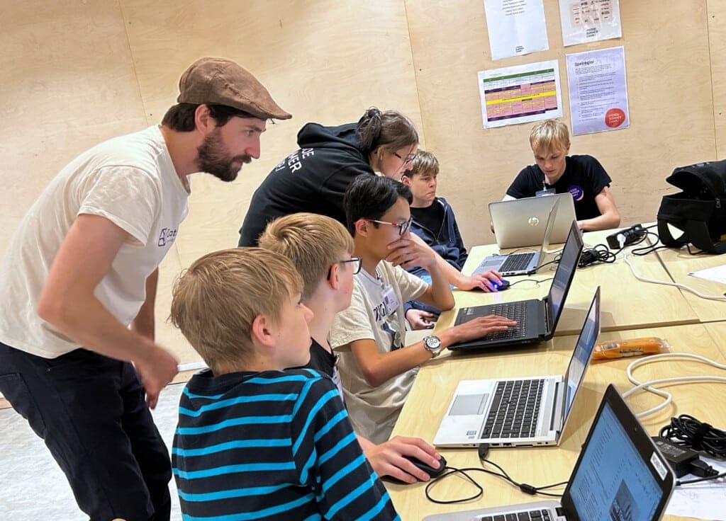 Students working with data at a laptop